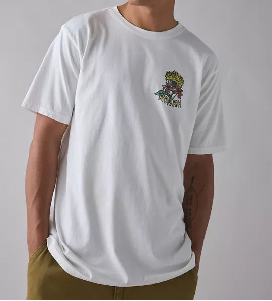 Man wearing a white t-shirt with a colorful graphic on a plain background