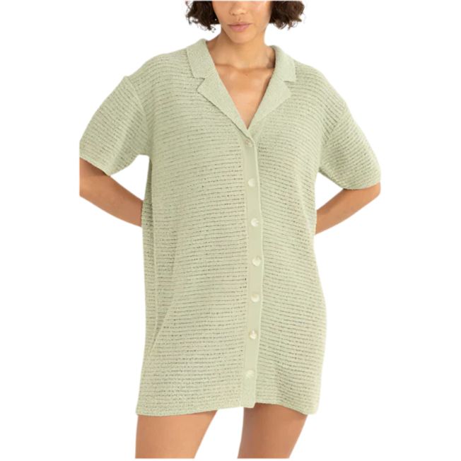 Woman wearing a light green textured shirt on a white background