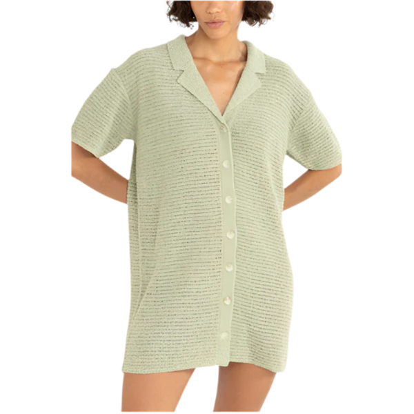 Woman wearing a light green textured shirt on a white background