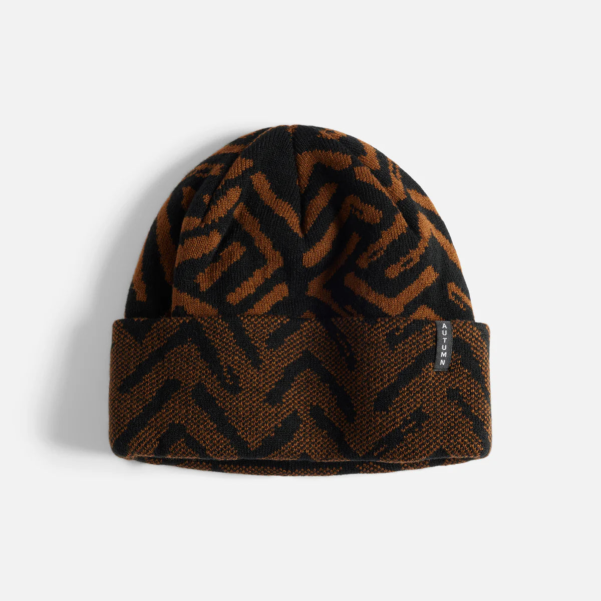 Brown and black patterned beanie on a light gray background