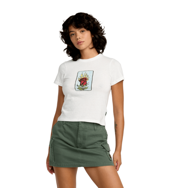 Woman wearing a white t-shirt with a graphic design and a green skirt on a white background